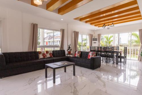 a living room with a couch and a table at Cozy crib in Saratoga with Jacuzzi in Tagaytay