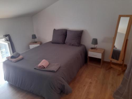 a bedroom with a bed with a pink towel on it at il fait bon vivre classé 3 étoiles in Montcuq