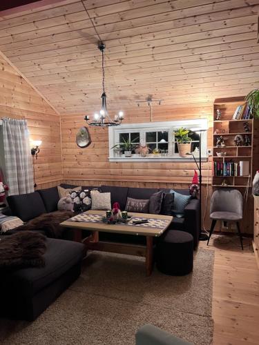 a living room with a couch and a table at Domek Iwony in Molde