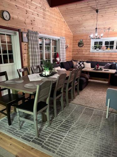a dining room with a table and chairs at Domek Iwony in Molde