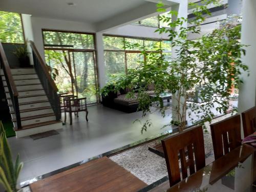 a living room filled with lots of plants at Gampaha Heritage in Gampaha
