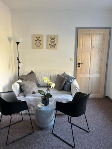 a living room with a couch and two chairs at Apartmány U Šťastných in Cerny Dul