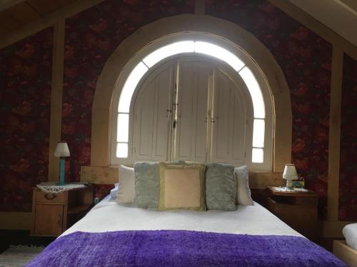 a bedroom with a large bed with a window at Loft del Rio in Cajon del Maipo