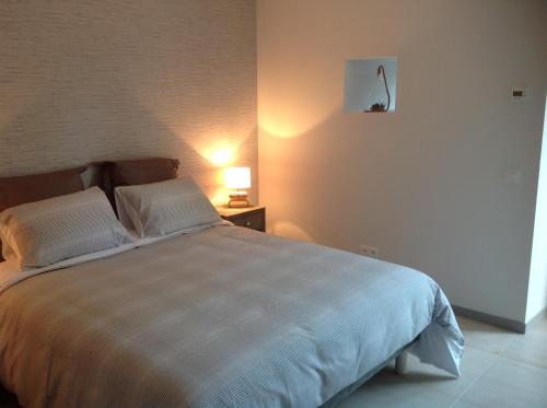 a bedroom with a large bed with two pillows at La Postellerie in Fleury