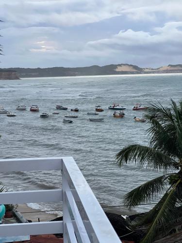 a view of a body of water with boats in it at Flat no UNICO HOTEL BEIRA MAR Pipas Bay 217 in Pipa