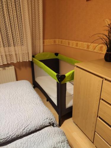 a bedroom with a green and black chair next to a bed at Flip-Flops Apartment Jurmala with free parking in Jūrmala