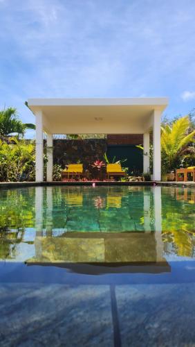 a swimming pool at a resort with a swimming pool at Villa O' in Cap Malheureux