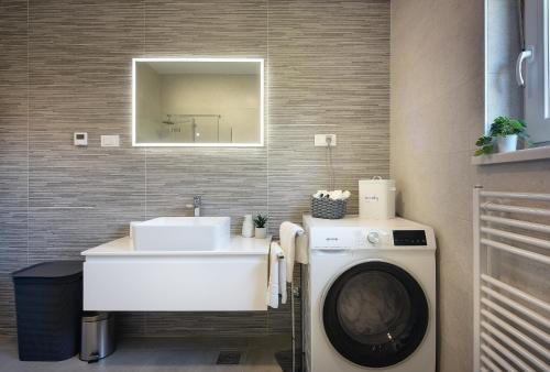 a bathroom with a washing machine and a sink at Vila Eia in Pula