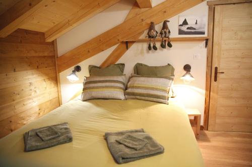a bedroom with a bed with two towels on it at Chalet La Trafolée in Manigod