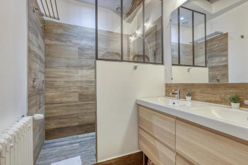 a bathroom with a sink and a mirror at Charming Designed Loft - Latin Quarter - Paris 05 in Paris