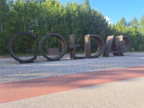 a large metal sign that says open on a street at Przytulne mieszkanie w centrum Gołdap in Gołdap
