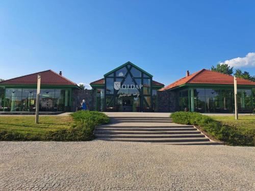 a building with a walkway in front of it at Przytulne mieszkanie w centrum Gołdap in Gołdap