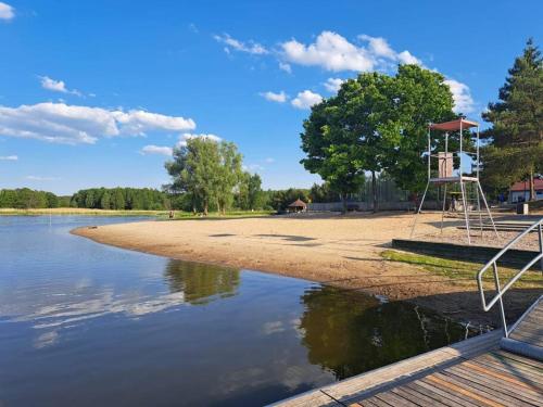 a park with a basketball hoop on the shore of a lake at Przytulne mieszkanie w centrum Gołdap in Gołdap