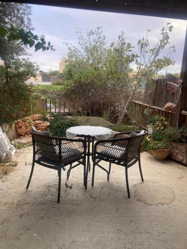 einen Tisch und zwei Stühle neben einem Tisch in der Unterkunft cozy room in Mitzpe Ramon
