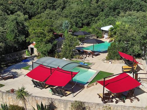 an overhead view of a pool with tables and umbrellas at Quinta das Cantigas by Book YourHoliday PT in Aljubarrota