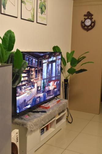 a flat screen tv sitting on top of a white entertainment center at Chillax Condotel - Shore Residences in Manila