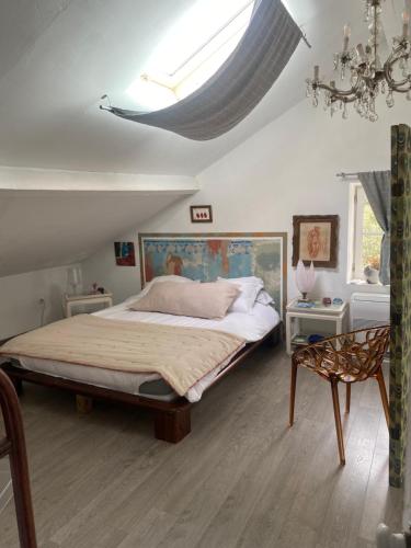 a bedroom with a large bed and a skylight at Mamma-Mia in Calvi