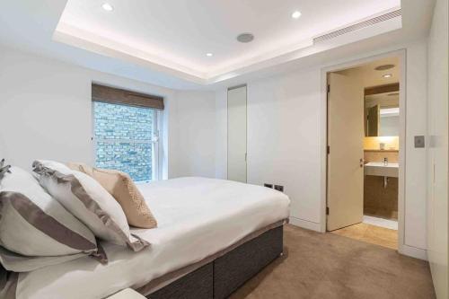 een slaapkamer met een groot bed en een badkamer bij London Mayfair W1 in Londen