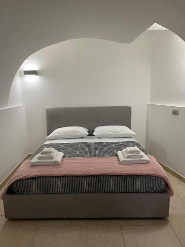 a bedroom with a bed with two towels on it at joy's home in Bari