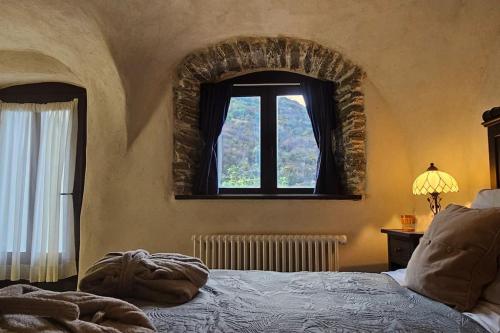 a bedroom with a bed and a window at Exceptional stone mountain house in Saint-Michel-de-Maurienne