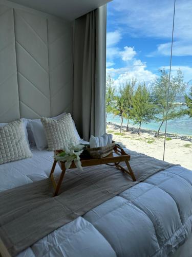 a bedroom with a bed with a view of the beach at Lazzlla beach front apartments in Hulhumale
