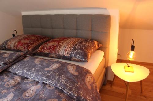 a bedroom with two beds with pillows and a table at Junker's Apartments in Salzburg