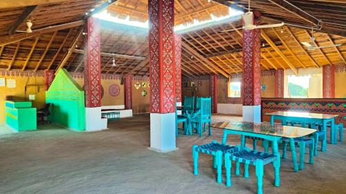 a large room with tables and chairs in it at HODKA RANN STAY Resort in Bherandiāla