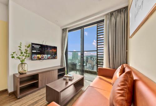 a living room with a couch and a large window at S Lux Apartment Virgo in Nha Trang