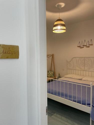 a bedroom with a bed and a light at TENUTA TAURIANUM PanoramicHouse e PanoramicB&B in Palmi