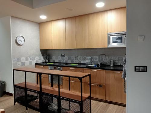 a kitchen with wooden cabinets and a counter top at Casa Rural IKIGAI, Viloria Navarra in Viloria