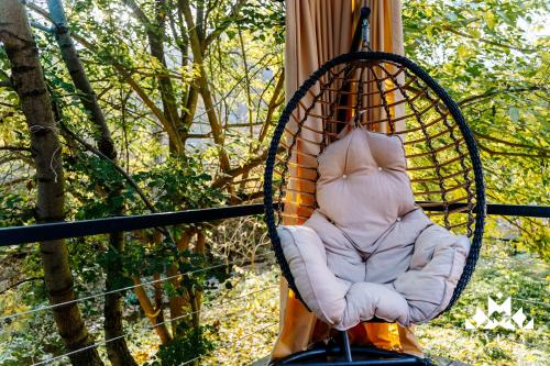 a seat in a hammock on a swing at Gipsy Village Park Hotel in Asuretʼi
