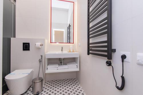 a bathroom with a sink and a toilet and a mirror at LUX Апартаменти MYFREEDOM поруч метро Театральна, Хрещатик in Kyiv