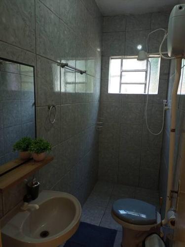 a bathroom with a sink and a toilet at Apto confortável com Churrasqueira 02 in Cachoeira do Sul