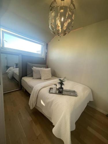a bedroom with a bed with a tray on it at Moderne leilighet med terrasse & gratis parkering in Kolbotn