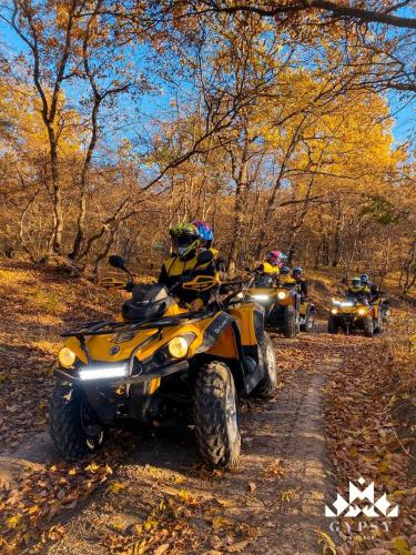 a group of people riding atvs on a trail at Gipsy Village Park Hotel in Asuretʼi