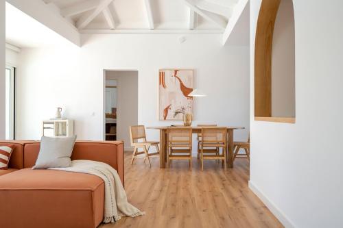 a living room with a couch and a table at Villa Tropico - Design house with pool in Corralejo in Corralejo