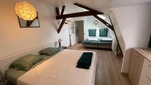 a bedroom with a large bed in a room at Au puits de l'abbaye in Bourges