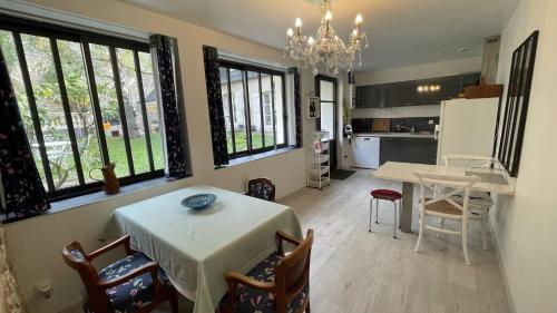 une cuisine et une salle à manger avec une table et des chaises dans l'établissement Au puits de l'abbaye, à Bourges