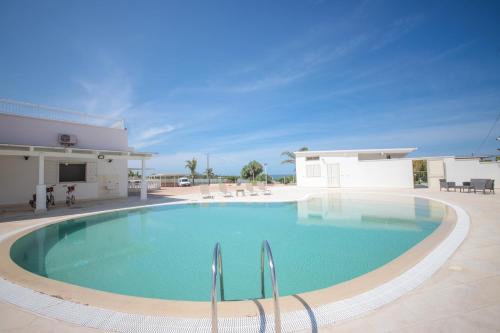 a large swimming pool in front of a house at Villa Ginevra la Dimora by Apulia Hospitality in Capitolo
