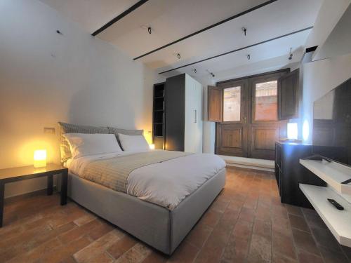 a bedroom with a large bed and a window at Appartamento davanti al Porto Romano in Bevagna