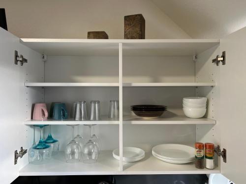 蓋爾森基興的住宿－Ewald，架子上盘子和盘子的白色餐具室