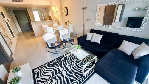 a living room with a blue couch and a table at Nova Beach Apartment 41 in Gran Alacant