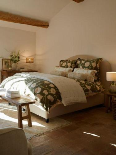 a bedroom with a bed and a wooden table at Chez Christ in Noisy-le-Grand