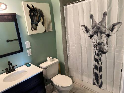 a bathroom with a giraffe head on the shower curtain at Chilled Pad 2 Blocks from the French Quarters in New Orleans