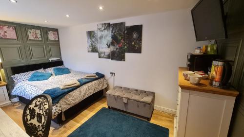 a bedroom with a bed and a table in it at Sea-Quinn Views in Wallasey