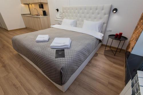 a bedroom with a large bed with two towels on it at LUX Апартаменти MYFREEDOM поруч метро Театральна, Хрещатик in Kyiv
