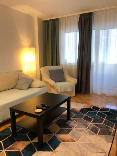 a living room with a couch and a coffee table at Adrian Home, Central in Ploieşti