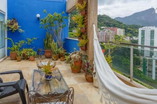 a hammock on a balcony with a view of a city at Cobertura duplex com vista panoramica na Gavea in Rio de Janeiro