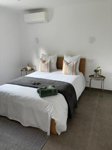 1 cama blanca grande en una habitación con 2 mesas en Les Oliviers en Arles