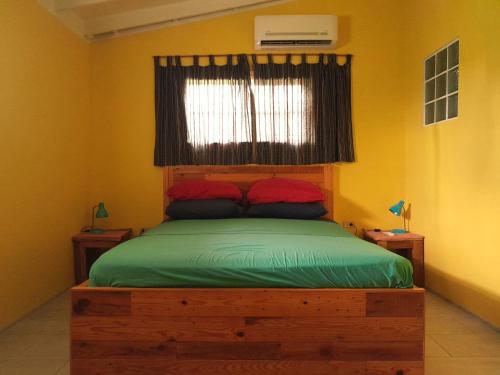 a bedroom with a wooden bed with a window at Hopi Cadushi Apartment in Santa Cruz